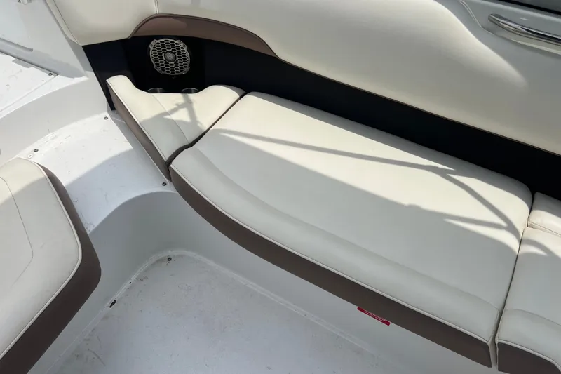 Slide: The Image of Interior seating of a 2012 Cobalt 220 boat with white and brown upholstery. - 15