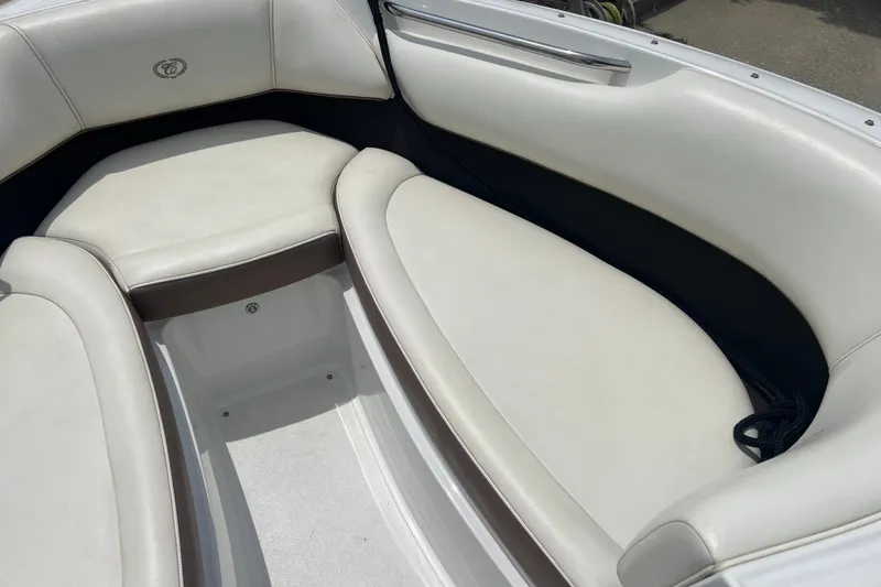 Slide: The Image of Interior seating of a 2012 Cobalt 220 boat, featuring white cushioned seats. - 19