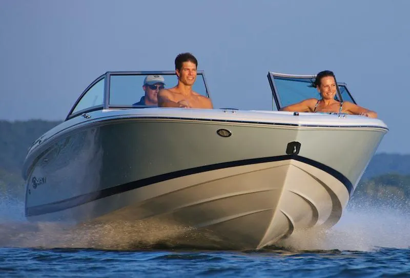 Slide: The Image of Manufacturer Provided Image: 2012 Cobalt 220 boat cruising on water with three passengers. - 23
