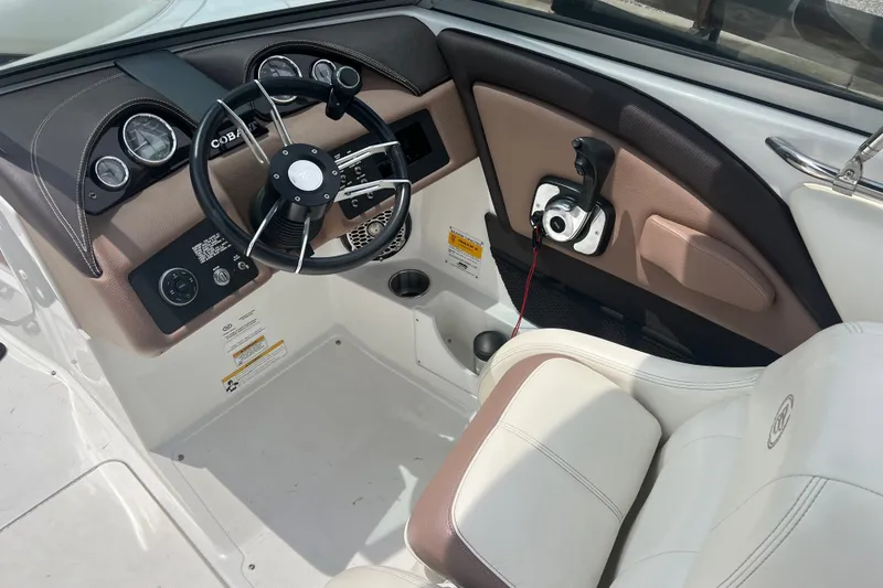 Slide: The Image of Interior of a 2012 Cobalt 220 boat featuring steering wheel and control panel. - 17