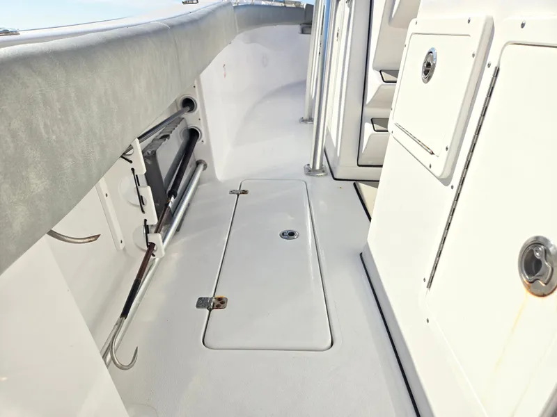 Slide: The Image of The image shows the deck of a 2020 Sportsman Open 282TE Center Console boat with storage compartments. - 10