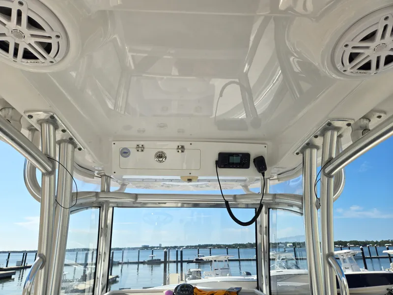 Slide: The Image of The image shows the cockpit of a 2020 Sportsman Open 282TE Center Console boat overlooking a marina. - 8