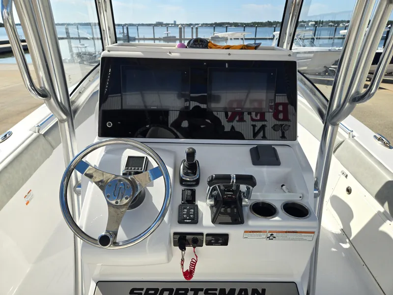 Slide: The Image of The image shows the helm of a 2020 Sportsman Open 282TE Center Console boat with modern instruments. - 7