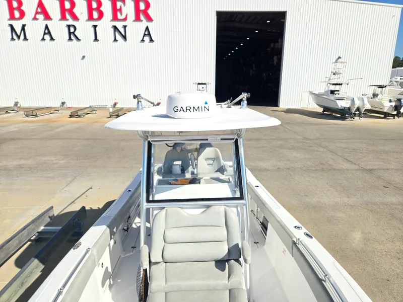 Slide: The Image of A 2020 Sportsman Open 282TE Center Console boat is in front of a marina. It features a Garmin radar. - 11
