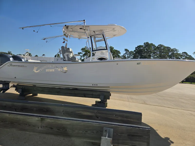 Slide: The Image of A 2020 Sportsman Open 282TE Center Console boat on a stand, ready for the water. - 2