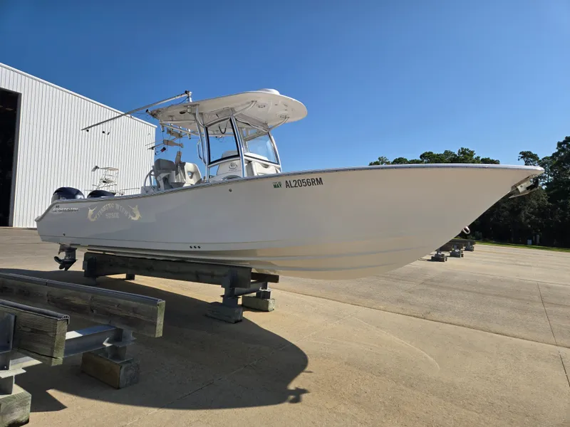 Slide: The Image of A white 2020 Sportsman Open 282TE Center Console boat is on a dry dock. - 3