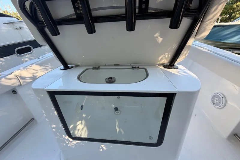Slide: The Image of 2023 Sea Hunt Gamefish 25 boat with open storage compartment and sleek design. - 13