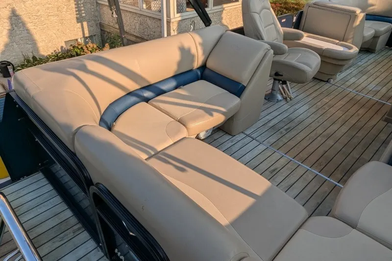 Slide: The Image of Luxurious seating on 2017 Manitou 23 Aurora VP pontoon boat with elegant wood flooring. - 1