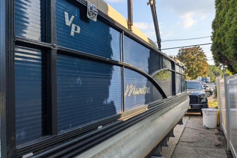 Slide: The Image of 2017 Manitou 23 Aurora VP pontoon boat parked outdoors. - 21