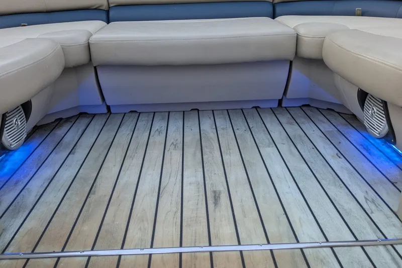 Slide: The Image of Luxurious interior of 2017 Manitou 23 Aurora VP boat with wood flooring and blue LED lighting. - 10