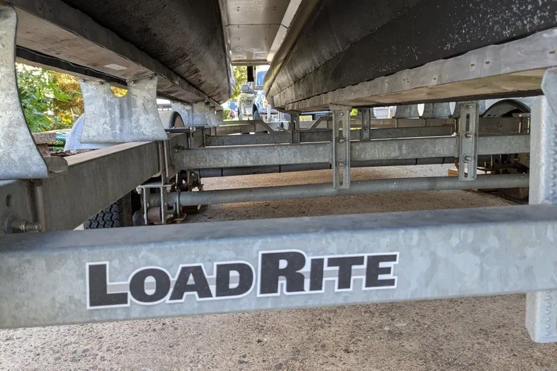 Slide: The Image of Underneath view of a 2017 Manitou 23 Aurora VP on a Load Rite trailer. - 18