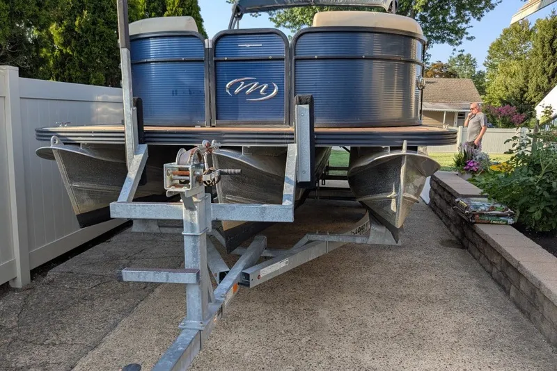 Slide: The Image of 2017 Manitou 23 Aurora VP pontoon boat on trailer in driveway. - 5