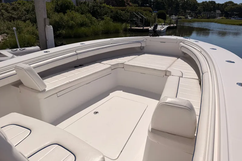 Slide: The Image of 2016 Regulator 34 boat with spacious white seating area by the water. - 20