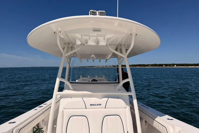Slide: The Image of 2016 Regulator 34 boat on open water, featuring a sleek design and spacious deck. - 29
