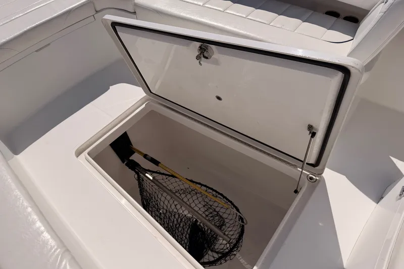 Slide: The Image of Open storage compartment on a 2016 Regulator 34 boat, containing a fishing net. - 33