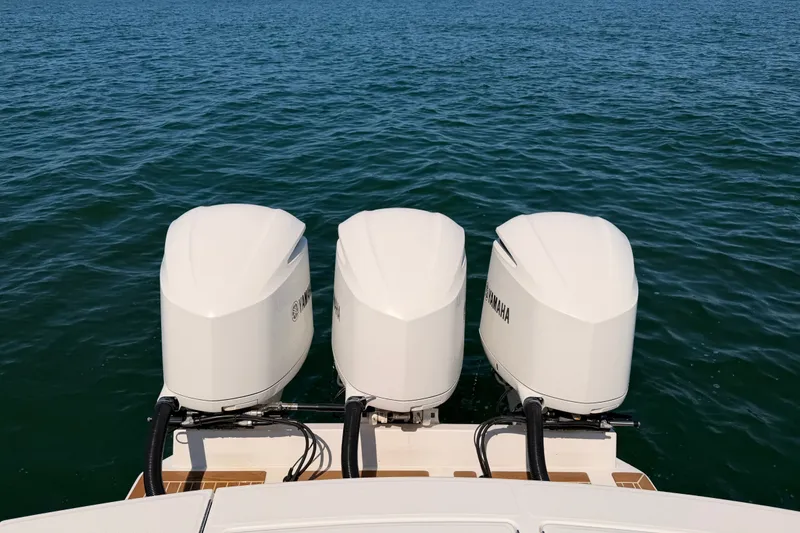 Slide: The Image of Triple Yamaha outboard engines on a 2016 Regulator 34 boat in open water. - 18