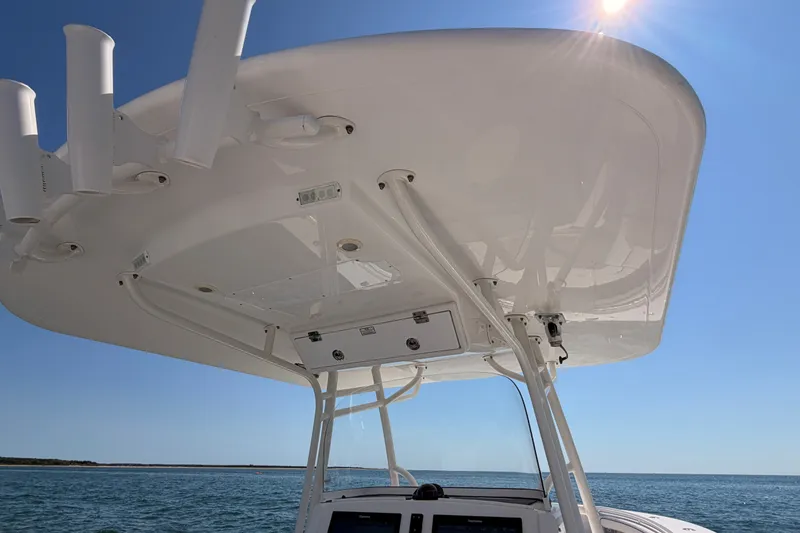 Slide: The Image of 2016 Regulator 34 boat's T-top under clear blue sky on open water. - 30
