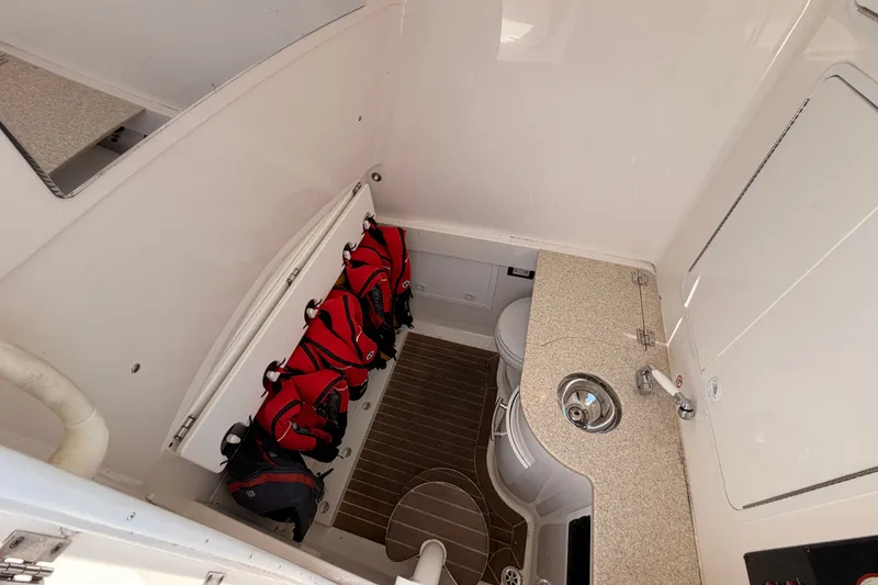 Slide: The Image of Interior of 2016 Regulator 34 boat with life jackets, sink, and toilet. - 37