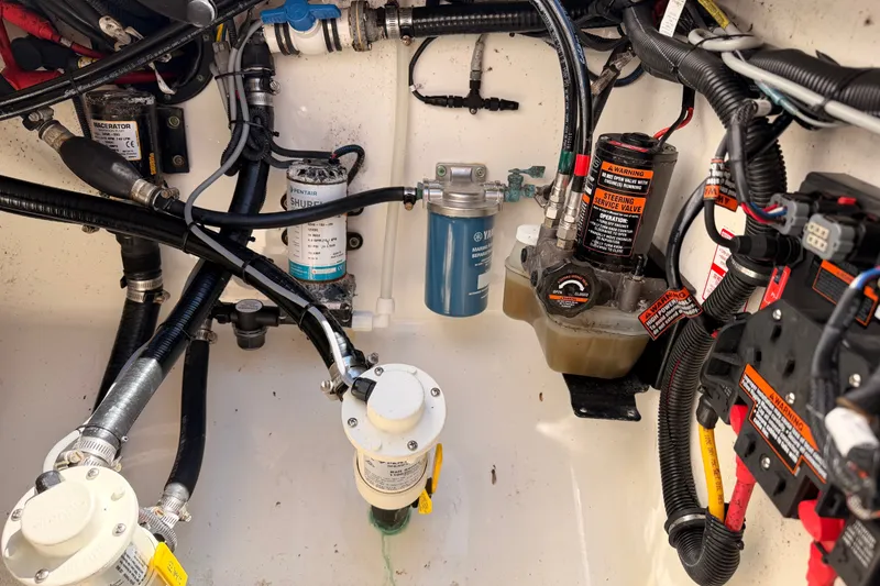 Slide: The Image of Engine compartment of a 2016 Regulator 34 boat, showcasing various mechanical components and wiring. - 35