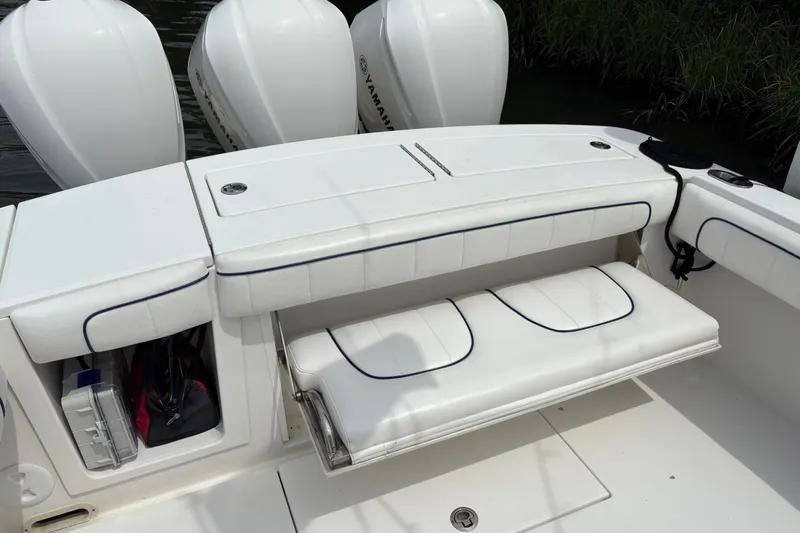 Slide: The Image of 2016 Regulator 34 boat with Yamaha engines and white cushioned seating. - 11