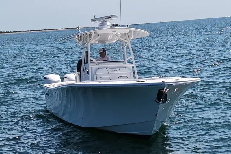 Slide: The Image of A 2016 Regulator 34 boat on the water with a driver at the helm. - 5