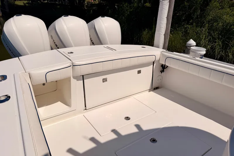Slide: The Image of 2016 Regulator 34 boat deck with Yamaha engines, featuring spacious seating and storage. - 16