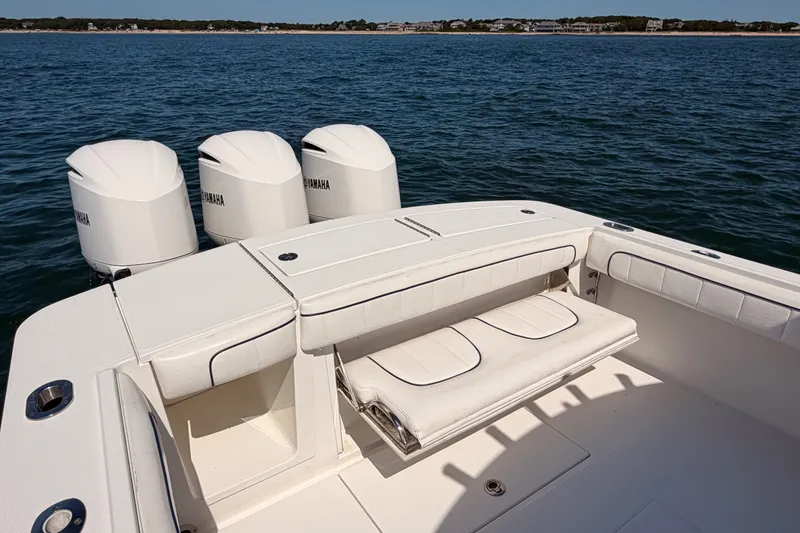 Slide: The Image of 2016 Regulator 34 boat with Yamaha engines, white seating, and ocean backdrop. - 17