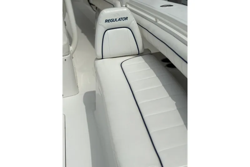 Slide: The Image of White leather seating on a 2016 Regulator 34 boat, featuring sleek design and comfort. - 13