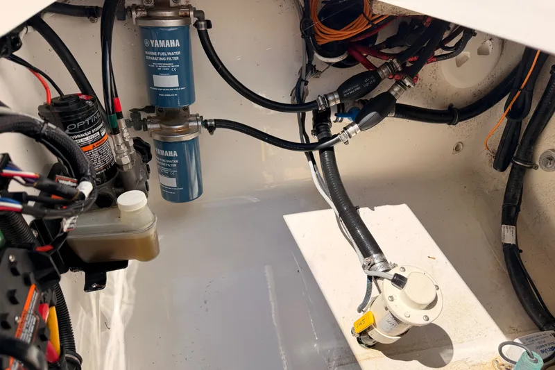 Slide: The Image of Engine compartment of a 2016 Regulator 34 boat with Yamaha fuel filters and hydraulic system. - 34