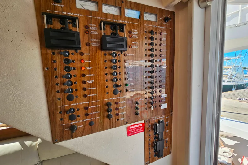 Slide: The Image of Control panel of a 2000 Mainship 39 Trawler, featuring switches and gauges. - 18