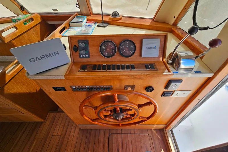 Slide: The Image of Helm of 2000 Mainship 39 Trawler with Garmin navigation equipment and wooden steering wheel. - 35