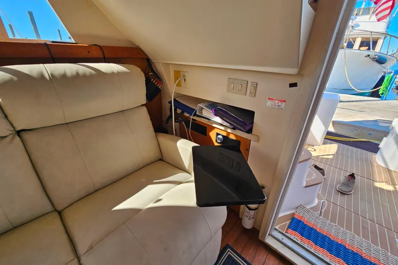 Slide: The Image of Cozy interior of 2000 Mainship 39 Trawler with beige seating and outdoor view. - 39