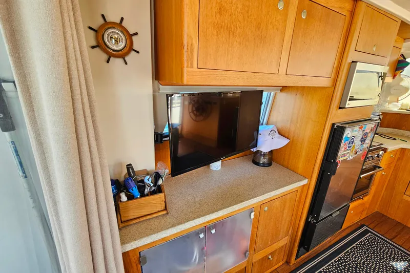 Slide: The Image of Interior of 2000 Mainship 39 Trawler with wooden cabinets and modern appliances. - 43