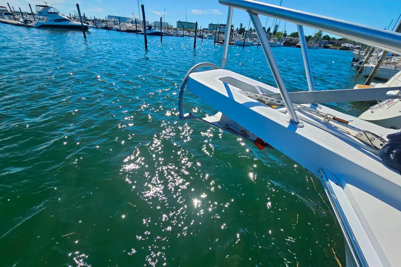 Slide: The Image of Bow of 2000 Mainship 39 Trawler in marina, sunlight reflecting on water. - 11
