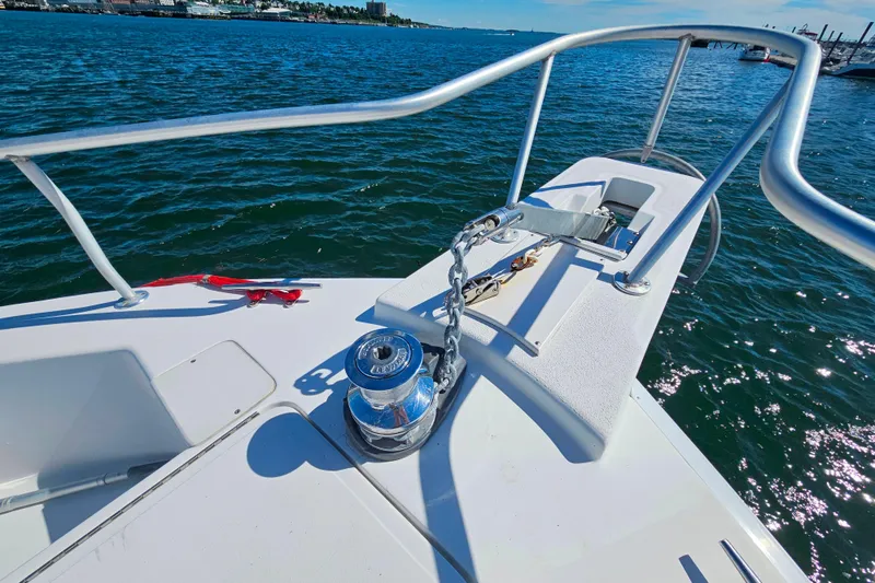 Slide: The Image of Bow of 2001 Mainship 39 Trawler with anchor chain and winch on open water. - 9