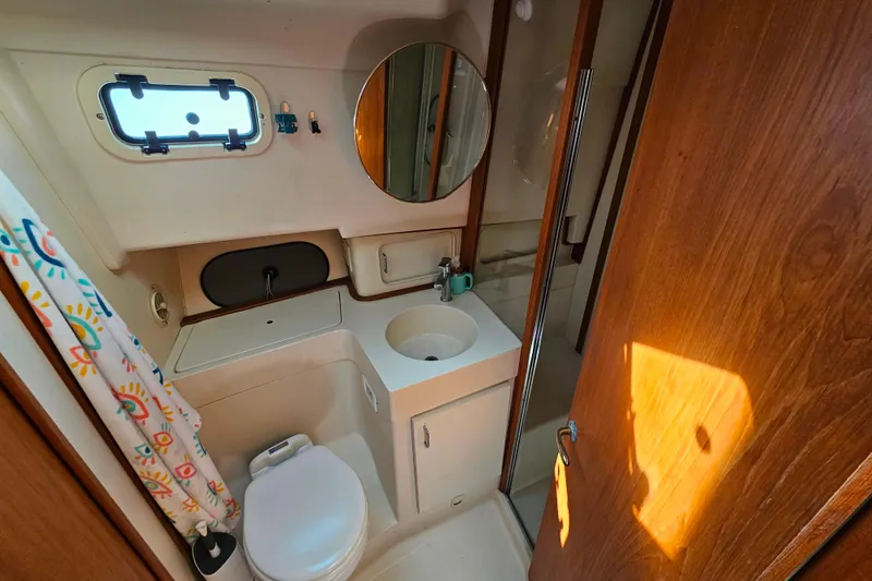 Slide: The Image of Bathroom interior of 2000 Mainship 39 Trawler with sink, toilet, and shower. - 45