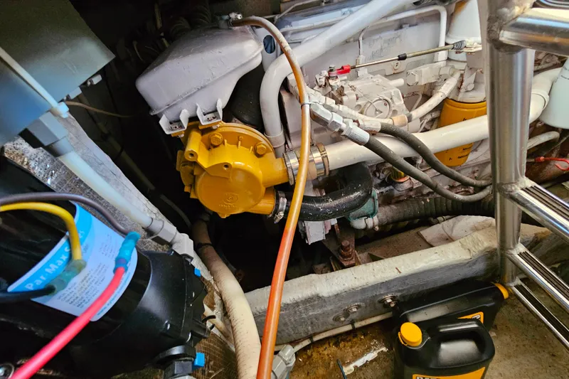 Slide: The Image of Engine room of a 2000 Mainship 39 Trawler, showcasing mechanical components and wiring. - 25