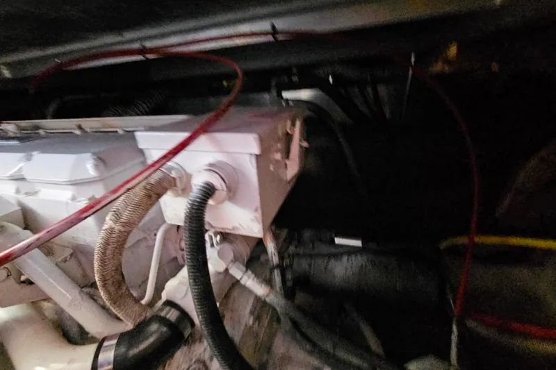 Slide: The Image of Engine compartment of a 2000 Mainship 39 Trawler with visible wiring and components. - 22