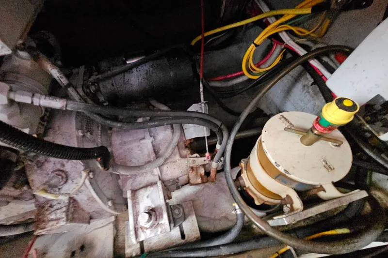 Slide: The Image of Engine compartment of a 2000 Mainship 39 Trawler with visible wiring and components. - 23