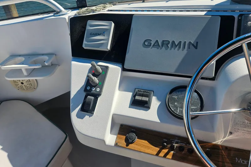 Slide: The Image of Helm of 2000 Mainship 39 Trawler featuring Garmin navigation system and controls. - 32