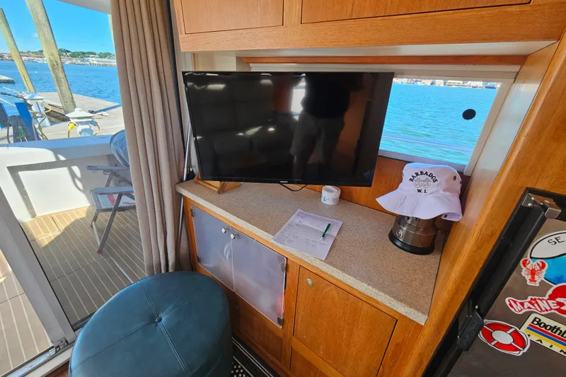 Slide: The Image of Interior of 2000 Mainship 39 Trawler with TV, countertop, and waterfront view. - 15