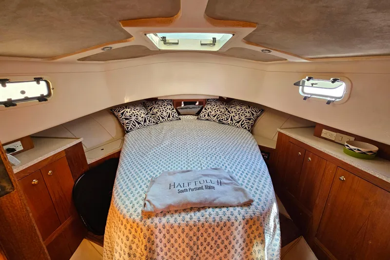Slide: The Image of Cozy cabin interior of 2000 Mainship 39 Trawler with bed and wooden cabinetry. - 46