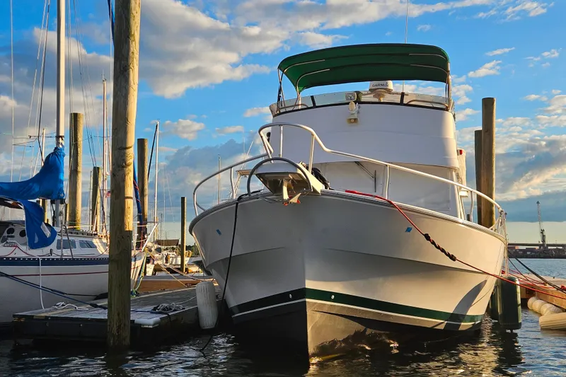 Slide: The Image of A 2000 Mainship 39 Trawler docked under a sunny sky. - 3