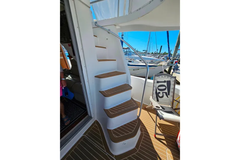 Slide: The Image of Staircase on 2000 Mainship 39 Trawler, leading to upper deck with marina view. - 21