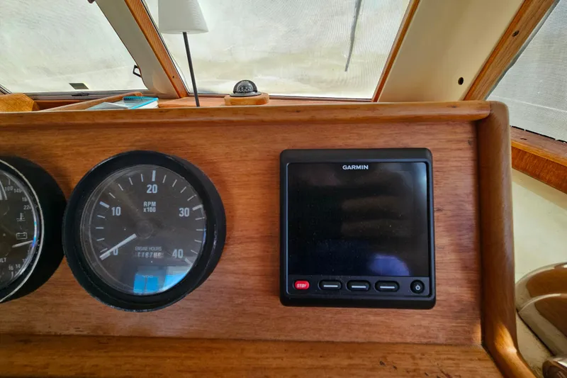 Slide: The Image of Mainship 39 Trawler 2000 dashboard with Garmin display and RPM gauge. - 37