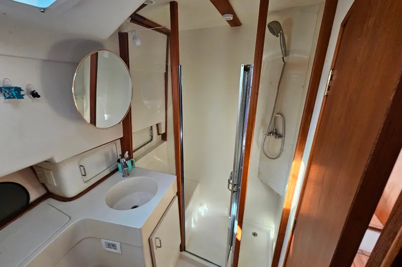 Slide: The Image of Bathroom interior of 2000 Mainship 39 Trawler with shower and sink. - 44