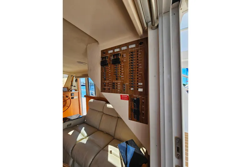Slide: The Image of Interior of 2000 Mainship 39 Trawler showing control panel and seating area. - 20