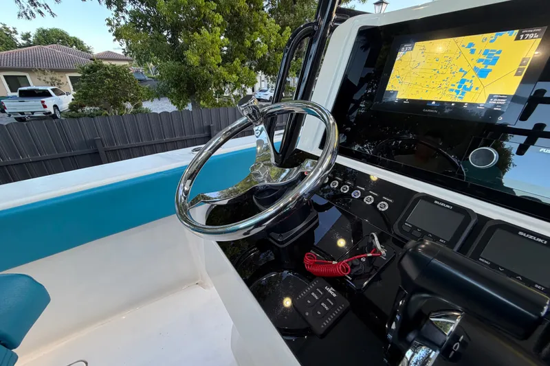 Slide: The Image of Steering console of 2023 Sea Tech 33 boat with navigation display and controls. - 37