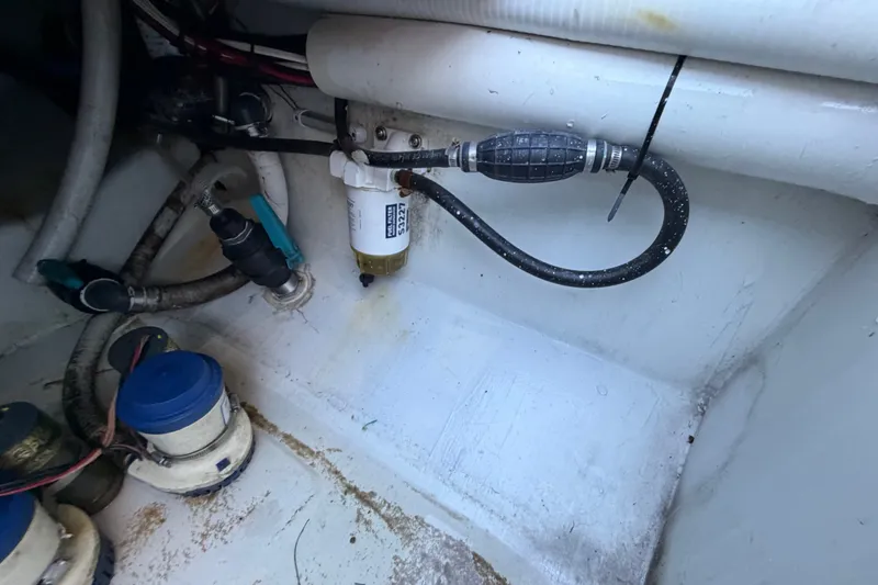 Slide: The Image of Engine compartment of 2023 Sea Tech 33 boat showing fuel filter and hoses. - 22