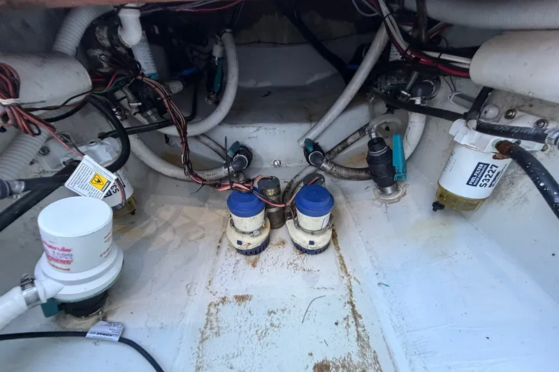 Slide: The Image of Engine compartment of a 2023 Sea Tech 33 boat, showcasing pumps and wiring. - 20
